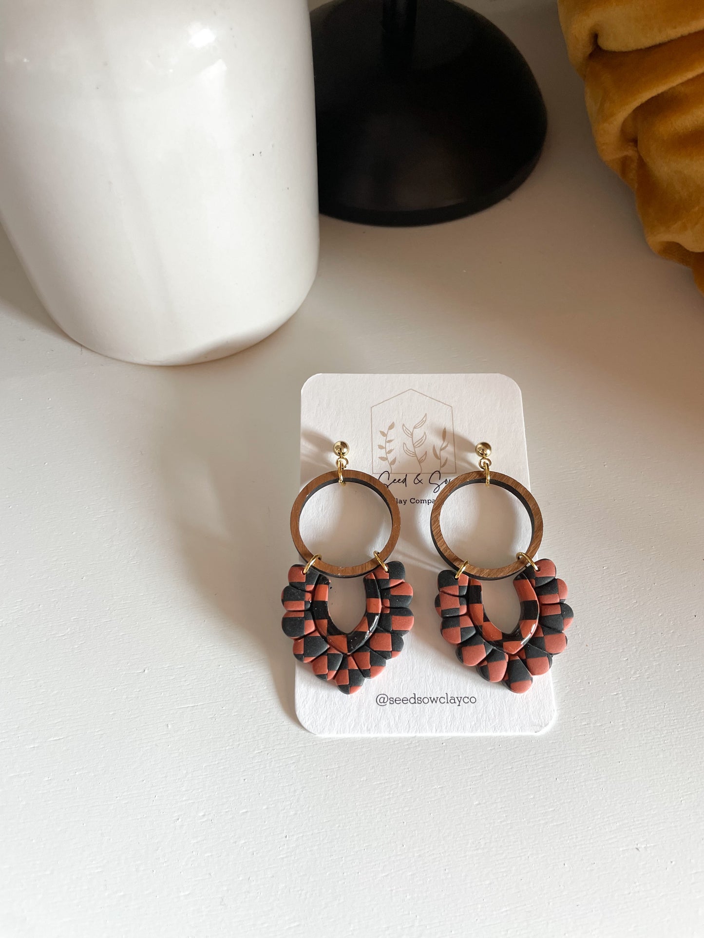 Black and Orange Checker Dangle on Wood